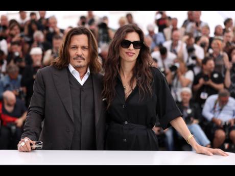 Credit: AP Johnny Depp (left), and director Maiwenn pose for photographers at the photo call for the film ‘Jeanne du Barry’ at the 76th international film festival in Cannes, southern France, on Wednesday.