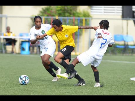 Credit: Kenyon Hemans
Cavalier SC’s Kadian Edwards (centre), dribbles away from the attentions of Vere United captain, Shahedah Graham (left) and July-Ann Howard during the teams’ Jamaica Women’s Premier League first-leg semifinal football game at the UWI-JFF Captain Hor