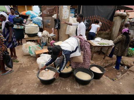 In this June 2022 photo women sell food items at a street market in Owo, Southwestern Nigeria. The United Nations is racing to extend a deal that has allowed for shipments of Ukrainian grain through the Black Sea to parts of the world struggling with hunge