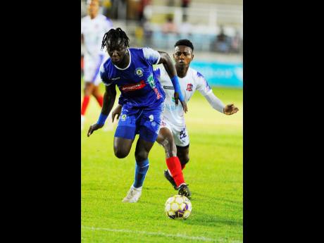 Credit: Nicholas Nunes/Photographer
Trivante Stewart (left) of Mount Pleasant dribbles past Zackiya Wilks of Dunbeholden during their Jamaica Premier League (JPL) match at Sabina Park tonight. Harbour View won 3-0 to advance to the semi-finals 4-1 on aggregate.