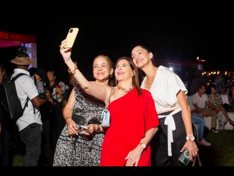 Managing director of Stewart’s Automotive Group Jackie Stewart Lechler (centre) snaps a selfie with Member of Parliament Ann-Marie Vaz (left) and Michelle Myers Mayne. 