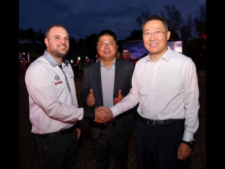 Brand manager at Stewart’s Automotive Group, Timothy Stewart (left), shares a moment with GWM sales and marketing director Zhou Jing (centre) and Chinese Ambassador to Jamaica, Chen Daojiang.
