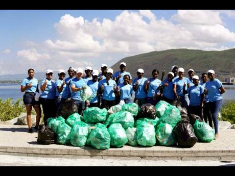 Members of the Carreras Ripon Road Corporate Office and Hagley Park depot pause for a group shot after collecting bags of garbage along the Palisadoes strip.