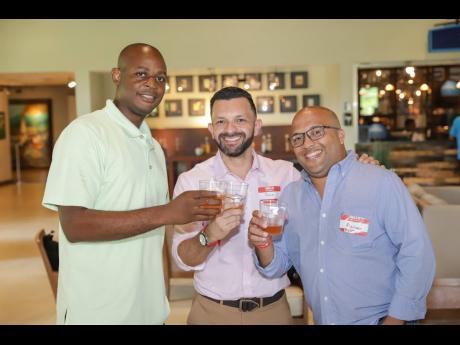 Ricardo Biggs, IT manager, Spanish Court Hotel; Julio Blanco, territory account manager, Avaya; and Bladmir Kellys Kreitz, senior sales manager, Wesco/Aniter, enjoy a welcome cocktail.