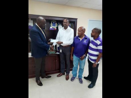 Credit: Corey Robinson Kingston College Principal Dave Myrie accepts a $515,000 donation from Class of 79 Old Boys Oliver Roper, Lindsay Ramsay, Robert McKenzie and Sydney England.