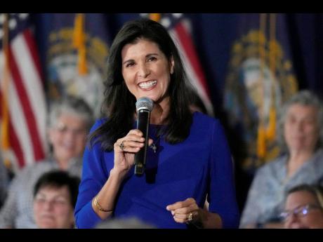 Republican presidential candidate Nikki Haley smiles while taking a question from the audience during a campaign gathering in Bedford, New Hampshire.