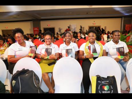 Participants with their One Love conference workbooks at the JMMB Joan Duncan Foundation’s  Conversation for Greatness conference held recently.