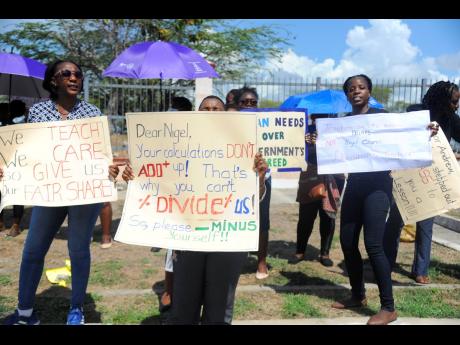 A group of teachers hold a demonstration in front of the offices of the Ministry of Finance and the Public Service at Heroes Circle on May 26.