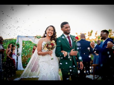 Confetti fills the air, as the husband and wife duo bask in nuptial bliss.