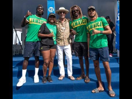 Jamaica surfers from left:  Javaun Brown, Imani Wilmot, Icah Wilmot and Elishama Beckford pose with International Surfing Association President Fernando Iguerre (centre) at the World Surfing Games in EL Salvador.