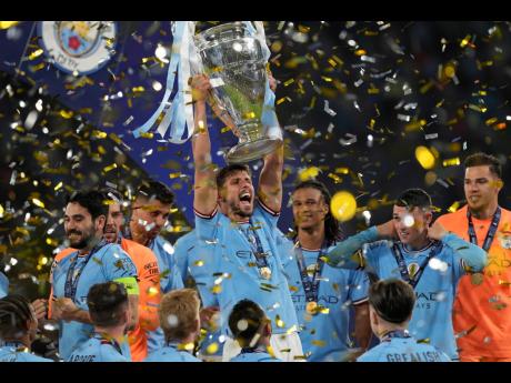
Manchester City’s Ruben Dias holds up the trophy after winning the Champions League final football match against Inter Milan at the Ataturk Olympic Stadium in Istanbul, Turkey, yesterday.