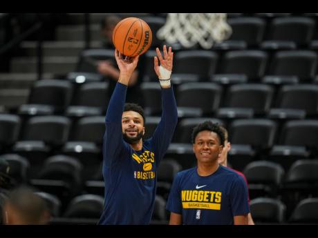 Denver Nuggets guard Jamal Murray (left) practises during an NBA Finals open practice yesterday in Denver. The Nuggets take on the Miami Heat in Game 5 of the NBA Finals tonight.