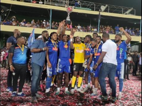 Credit: Nicholas Nunes Mount Pleasant players and staff celebrate winning the Jamaica Premier League title for the first time after a 2-1 win over Cavalier in the final at Sabina Park last night.