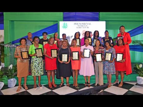 Phenomenal women in agricultural education awarded by the Jamaica Agricultural Society display their plaques during the entity’s ‘Women in Agriculture’ conference,  held at the Terra Nova All-Suite Hotel on June 14 under the theme ‘From Boots to He