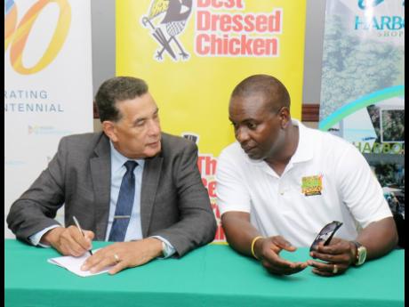 Homer Davis, minister of State in the Office of the Prime Minister - West (left) and John Lindo, organiser, MoBay Jerk and Food Festival, in conversation during the media launch at Holiday Inn, Rose Hall, St James on Thursday.