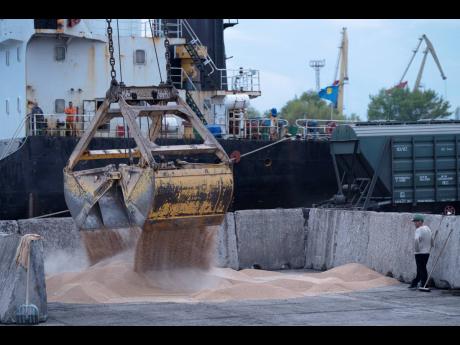 
Workers load grain at a grain port in Izmail, Ukraine, on April 26.