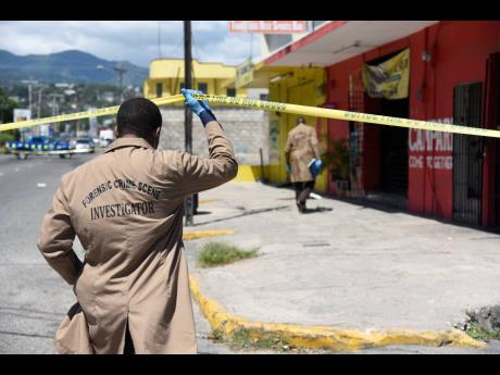 In this May 2021 photo, forensic crime scene investigators are seen entering a scene of crime in Swallowfield, Old Hope Road, where businessman Robert Fletcher was shot dead.