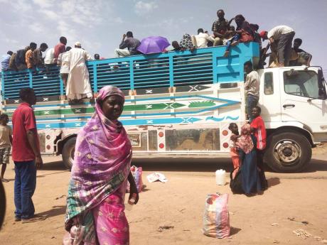 Credit: Uncredited People board a truck as they leave Khartoum in Sudan yesterday. Sudan’s warring parties have begun another attempt at a ceasefire after more than two months of brutal fighting.