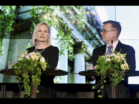 Credit: Jussi Nukari The new government of Finland led by Prime Minister Petteri Orpo (right) and the new minister of finance, Riikka Purra, holds a press conference in Helsinki, Finland, on Tuesday.