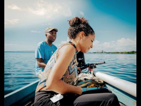 Khalia Hall, ESIROM sustainability coordinator, and Densel Edwards, fisherman and environmentalist, on one of their many trips taken to capture and show on social media the state of the harbour and its effects.