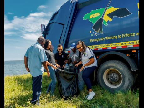 From left: Andrew Stewart, NWSMA truck driver; Khalia Hall, ESIROM sustainability coordinator; and Alex Morrissey, ESIROM boss, join fisherman and environmentalist, Densel Edwards;  Kimberley Blair, and NSWMA community relations officers for a clean-up at 