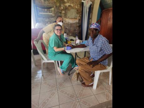 Alfred Graham has his pressure tested at the health fair by a member  of AOJAH.