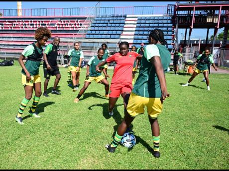 Head coach Lorne Donaldson (second left) conducting a training session with the Reggae Girlz at the Anthony Spaulding Sports Complex, Arnett Gardens, on Wednesday, June 14, 2023.