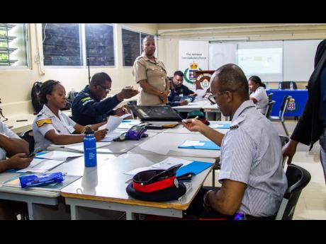 Members of the JCF attend a training of trainers workshop for police officers on how to   professionally handle cases of gender based violence.