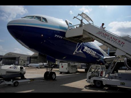 A man walks down the steps of the Boeing 777X airplane during the Paris Air Show in Le Bourget, north of Paris, France, on Monday, June 19, 2023. Airlines are facing increasing pressure to cut their climate-changing emissions. 