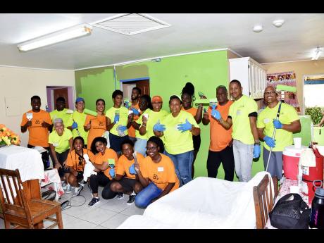 Members of the Florida, United States-based Rotary Club of Miami Kendall and their sponsor, Sunny Isle Hair & Skincare, take a break from painting at the SOS Children’s Village during work for their service project for 2023. 
