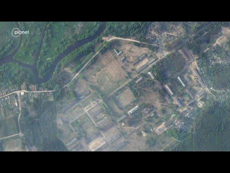 Credit: This satellite image provided by Planet Labs PBC taken on Thursday, June 15, 2023, shows a former military base outside the Belarusian town of Osipovichi shows no signs of the structures that appeared two weeks later.