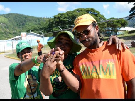 In this 2016 photo, supporters of JLP and PNP pose for a photo after casting their votes in the local government election. Ronald Thwaites writes:  ‘... the most significant result of Don Anderson’s recent poll was not the party standings, but ... majo