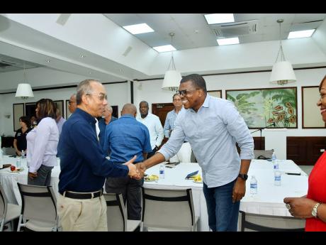 Credit: Contributed Dr Horace Chang (left), minister of national security, is greeted by Dr Ransford Davidson, president of the St Ann Chamber of Commerce, during a stakeholders’ meeting, held at Couples San Souci Hotel, Ocho Rios in St Ann on Saturday.