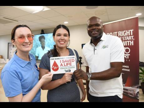 Credit: Contributed Embassy of Cuba in Jamaica diplomat and proud blood donor, Anabel Landron Ochoa (centre), is flanked by Musson Foundation Chairperson Melanie Subratie, and GenAc Executive Director Gregory S. Foster at the General Accident blood drive held on June 16 at 58
