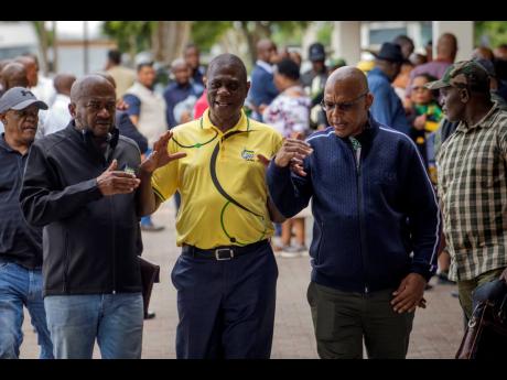 South African Deputy President Paul Mashatile (centre) walks out following a meeting of the ANC’s national executive committee, in Johannesburg, South Africa, in December 2022. Mashatile’s office said Tuesday that a video showing armed police assaultin