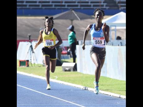 St Catherine High School's Kittania Headley (right) runs towards a famous girls' under-20 national title, finishing ahead of Alphansus Davis' Kishay Rowe during the JAAA/PUMA NAtional senior and Junior Championships inside the National Stadium earlier toda