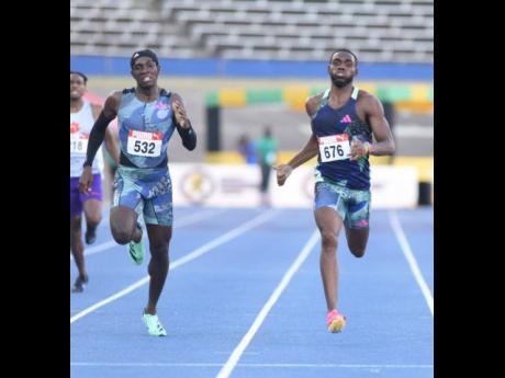 Sean Bailey (right) fights off the challenge of Antonio Watson on his way to winning the men's 400-metre title at the JAAA/PUMA National Senior and Junior Championships inside the National Stadium this evening.