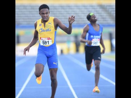 St Elizabeth's Enrique Webster dips for the line on his way to copping the boys' under-20 400-metre title at the JAAA/PUMA National Senior and Junior Chmpionships inside the National Stadium earlier today.