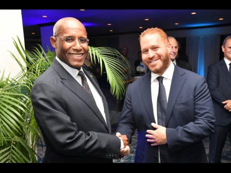 Minister of Industry, Investment and Commerce, Senator Aubyn Hill (left), with Chief Executive Officer of ANSA McAL Group of Companies, Anthony N. Sabga III, during a reception hosted by the company for local business stakeholders on July 6 at The Jamaica 