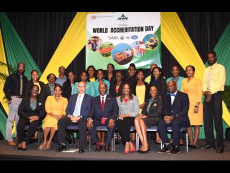 Minister of Industry, Investment and Commerce, Senator Aubyn Hill (centre, seated), with executives of the Jamaica National Agency for Accreditation (JANAAC) during the entity’s CEO Breakfast at The Jamaica Pegasus hotel in New Kingston on June 9, where 