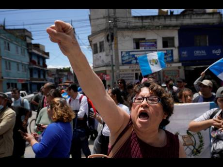 Protesters gather outside the Attorney General’s Office to protest its raid on the nation’s electoral authority and in favour of the election results that called for a run-off presidential election in Guatemala City yesterday. The Attorney General’s 