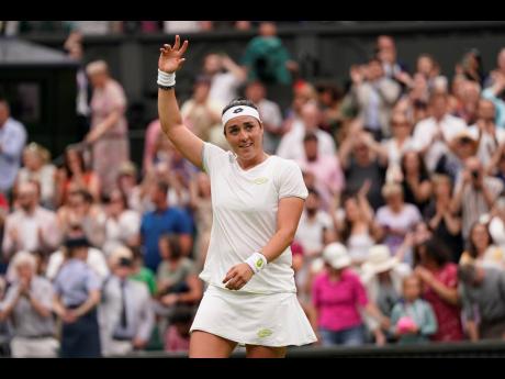 Credit: AP Tunisia’s Ons Jabeur celebrates after beating Aryna Sabalenka of Belarus to win their women’s singles semi-final match on day eleven of the Wimbledon tennis championships in London yesterday.
