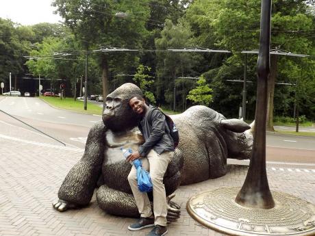 In true tourist mode, Adrian Wanliss chills with this gorilla structure in Amsterdam.