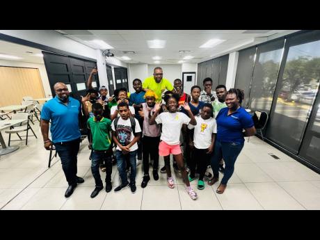 DJ Denvo (centre), joins members of the JWN Foundation team, Mark Telfer (left) and Samantha Blake (right) with some of the students from the one week summer camp in their final photo.
