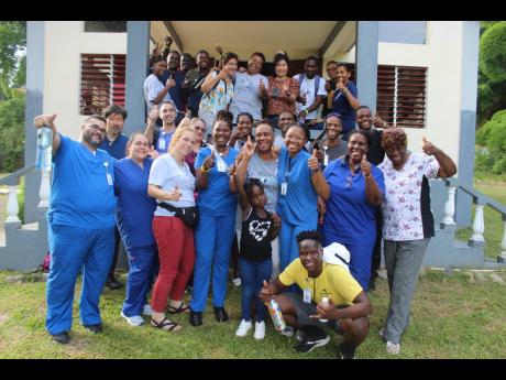 
The team from The Seven Eyes Stone Ministries, who held a health fair at Aleppo Central Gospel Chapel in St Mary, recently, and some local volunteers, giving the thumbs-up after a day well spent.
