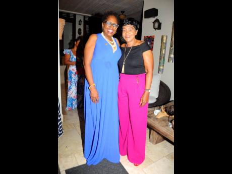 Resting firmly in their feminine energy for the evening, members of parliament Angela Brown Burke (left) and Denise Daley pose in complementary colours.