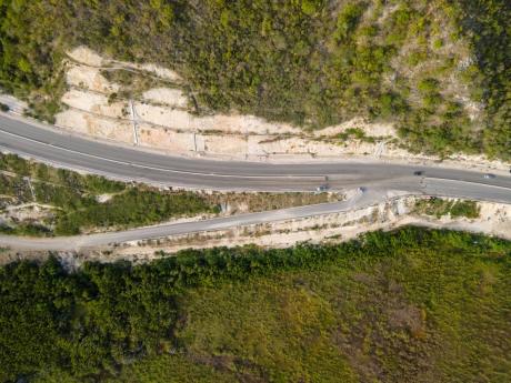 An aerial photograph taken in April 2023 shows the entryway into Grants Pen from the Highway bypass developed under the Southern Coastal Highway Improvement Project. 