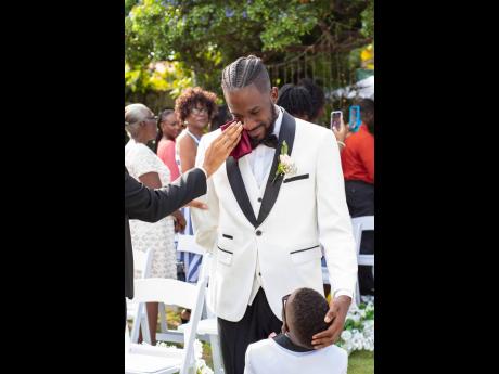 Overcome with emotions, the dashing groom, who is suited in classic black and white, could not hold back the tears as his beautiful bride walked up the aisle.