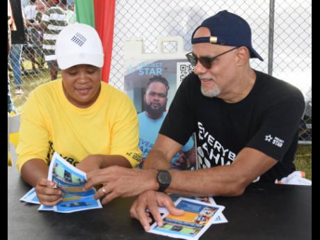 Keith Duncan (right), co-chairman of Project STAR, and Mickeemie Wedderburn in conversation at the Reggae Sumfest Family Funday Community Fest at Catherine Hall Stadium in Montego Bay on Sunday.