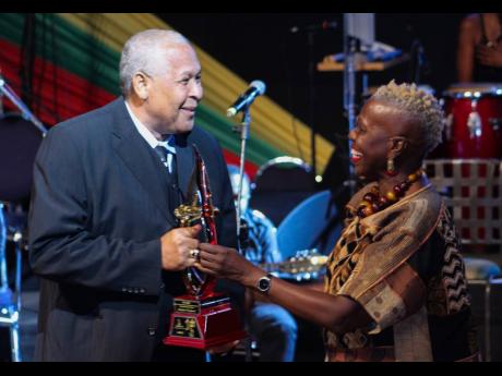 Credit: File
Producer Lloyd ‘King Jammy’ James (left), accepts an award from Carolyn Cooper at a 2015 staging of the Jamaica Reggae Industry Association Honour Awards.
